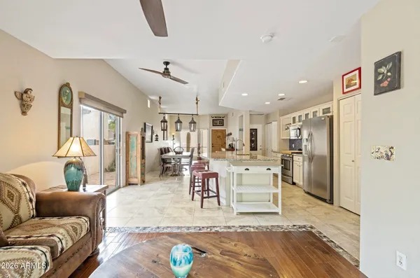 a living room with furniture and kitchen view