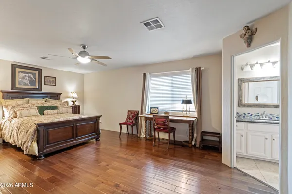 a spacious bedroom with a bed and a table in it