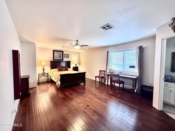 a bedroom with furniture and a wooden floor