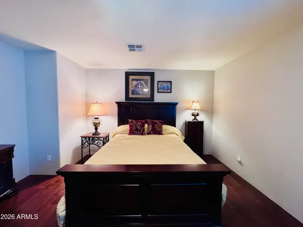 a bedroom with a bed and a night stand