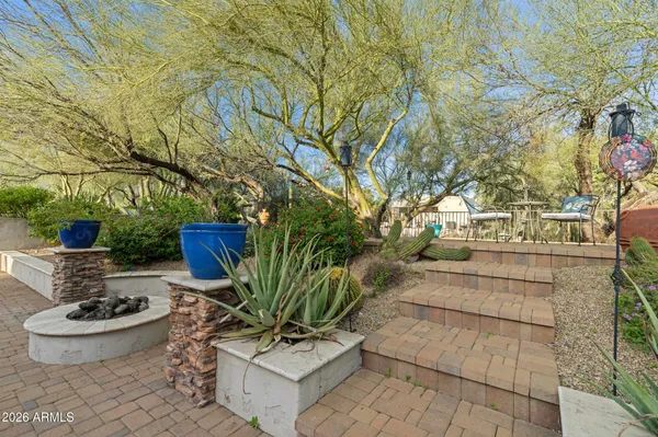 a view of a chairs and table in backyard