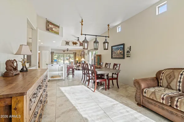 a living room with furniture a flat screen tv and kitchen view
