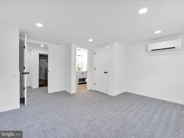 an empty room with closet and a bathroom