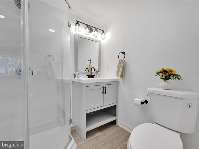 a bathroom with a sink a toilet and shower