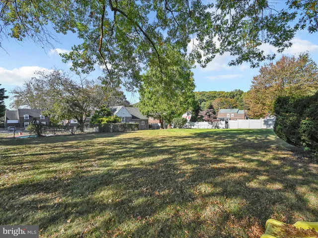 a view of a green field with clear tree