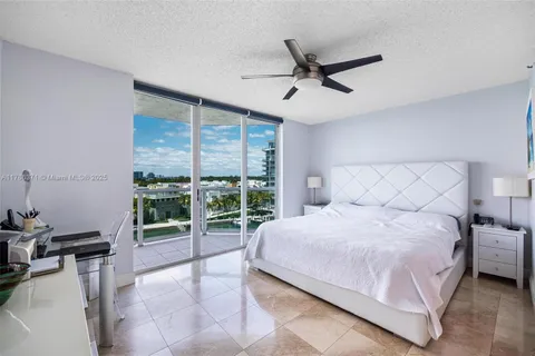 a bedroom with a bed and a large window