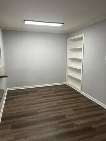 a view of room with wooden floor
