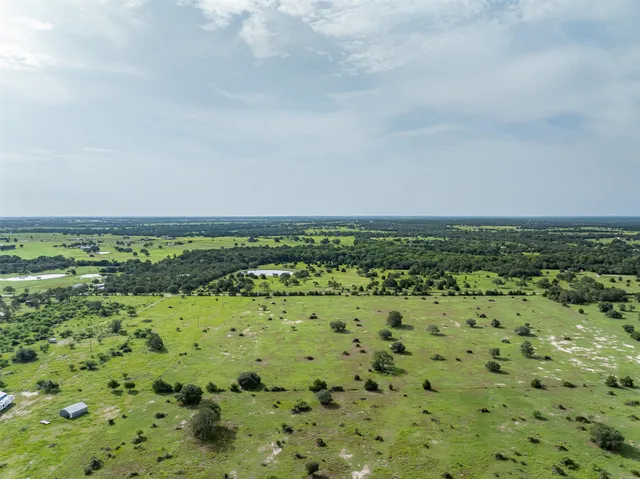 a view of a field with an ocean