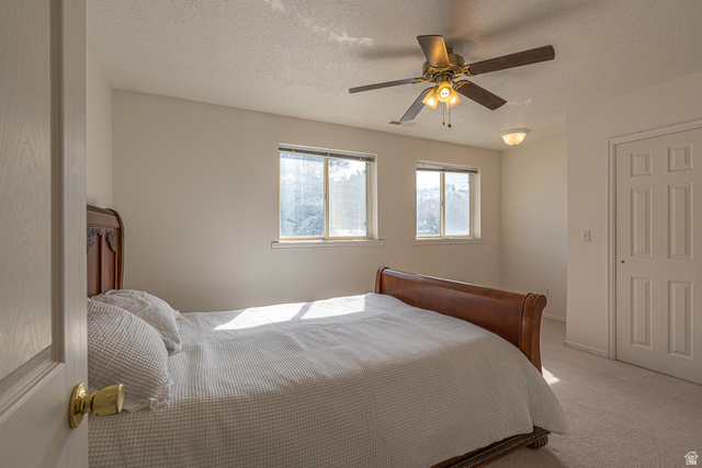 1045 Fox Farm Road Logan, UT 84321 - Photo 40 of 65 Carpeted bedroom featuring a textured ceiling and a ceiling fan