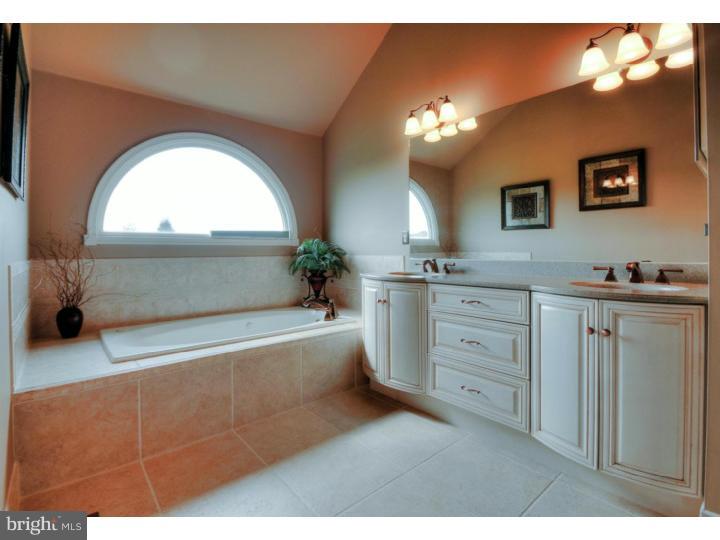 20 Zaitz Farm Road Princeton Junction, NJ 08550 - Photo 16 of 25 a spacious bathroom with a double vanity sink a two mirror a bathtub and a window