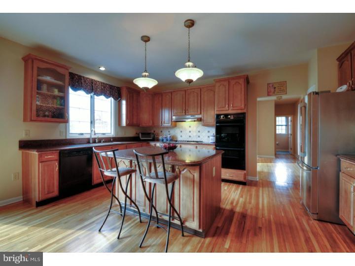 20 Zaitz Farm Road Princeton Junction, NJ 08550 - Photo 9 of 25 a kitchen with stainless steel appliances granite countertop wooden floors a stove and a refrigerator