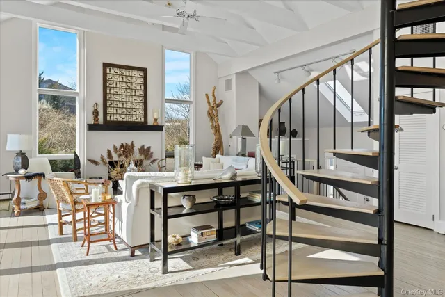 a view of hall way with furniture and rug