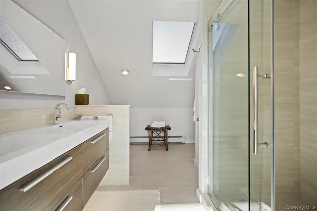 a spacious bathroom with a double vanity sink and a mirror