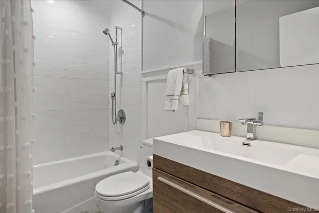 a bathroom with a sink a toilet and a bathtub