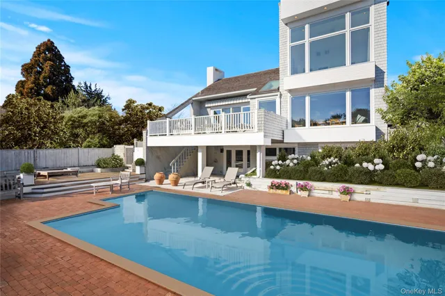 a view of a house with sitting area and swimming pool