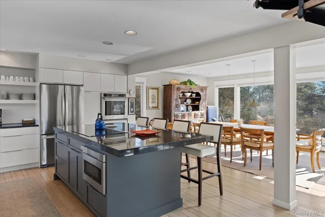 a kitchen with stainless steel appliances granite countertop a stove and a refrigerator