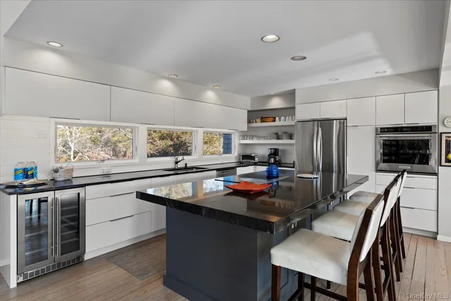 a kitchen with stainless steel appliances granite countertop a sink refrigerator and microwave