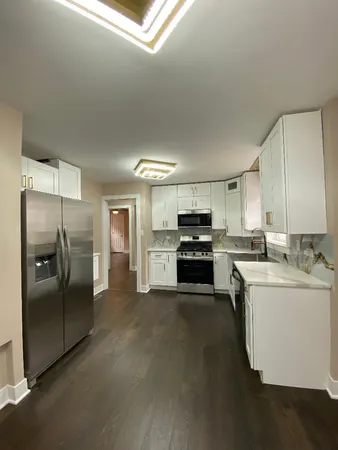 a kitchen with stainless steel appliances kitchen island a refrigerator sink and stove