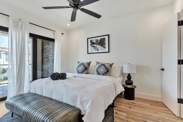 a bedroom with a bed and a large window