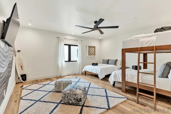 a living room with furniture a rug and white walls