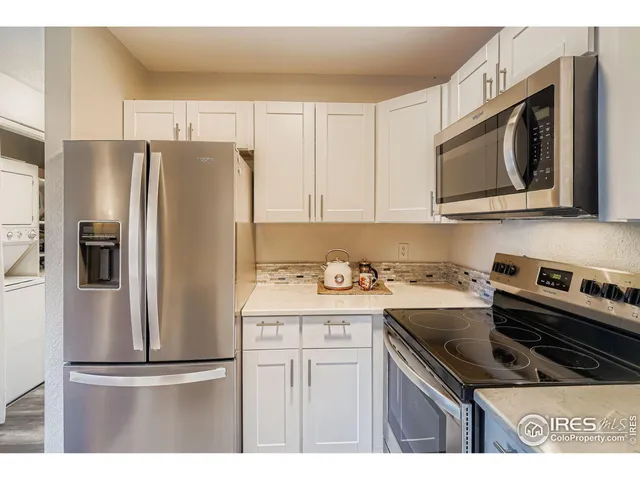 a kitchen with stainless steel appliances granite countertop a refrigerator stove and microwave