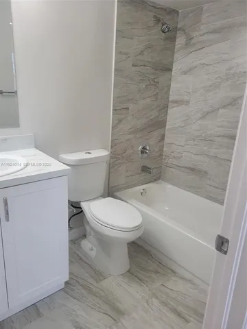 a view of a room with wooden floor and a window