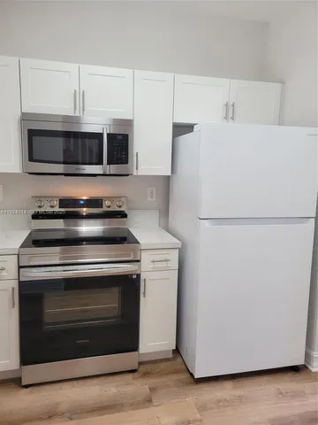 a white refrigerator freezer sitting in a kitchen