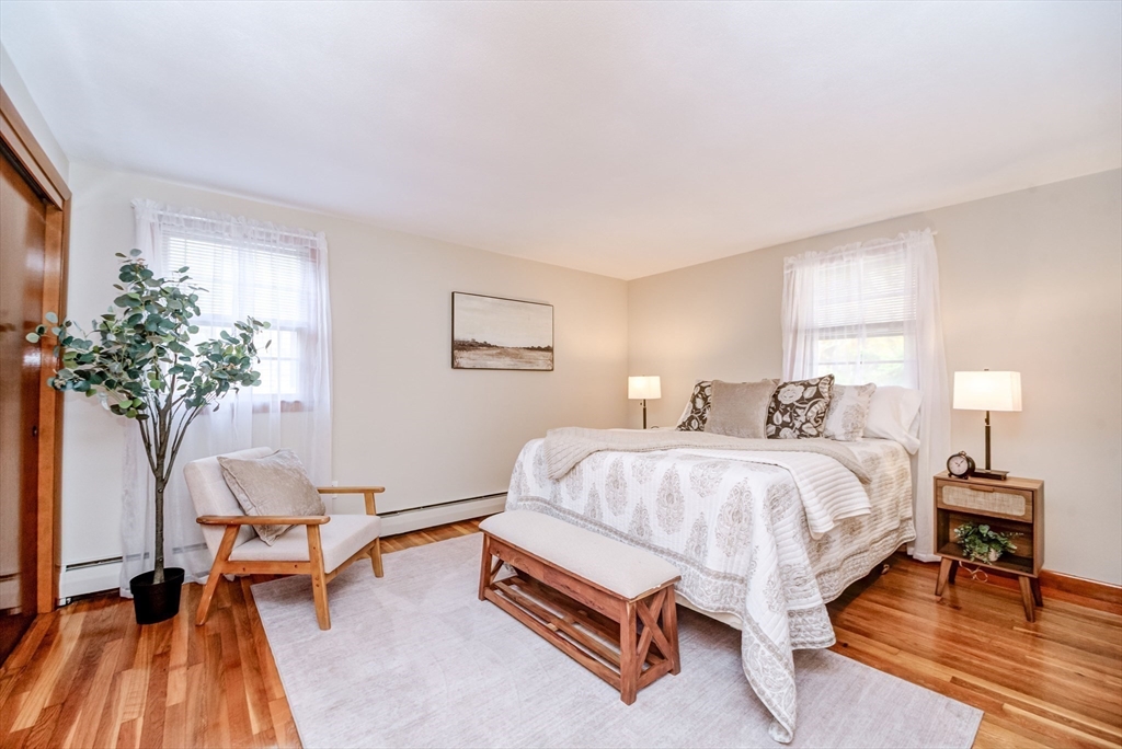 32 Staaf Road Saugus, MA 01906 - Photo 13 of 17 a spacious bedroom with a bed and a potted plant