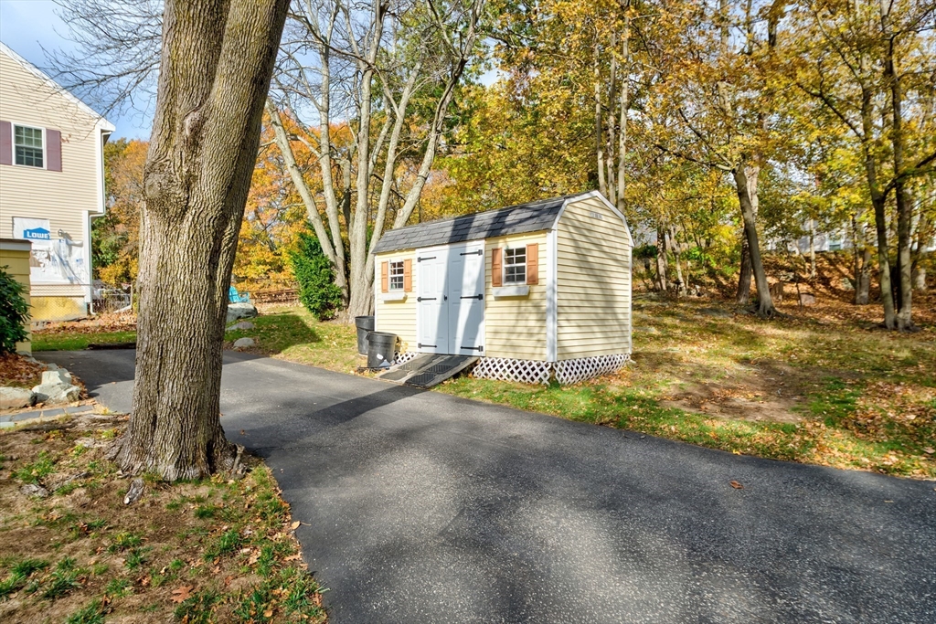 32 Staaf Road Saugus, MA 01906 - Photo 4 of 17 a view of a yard with plants and a tree
