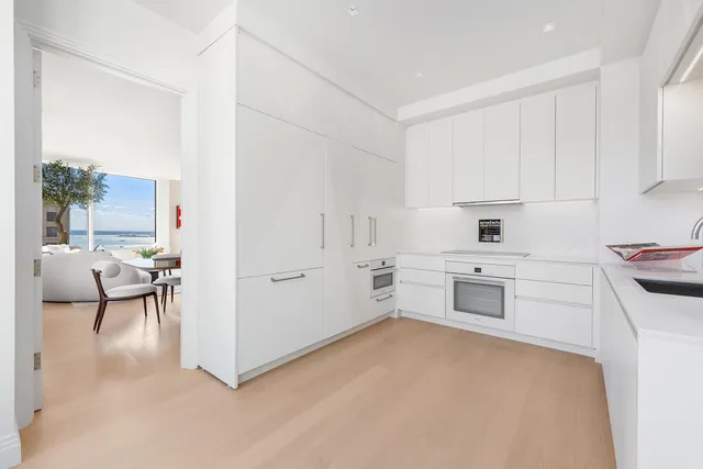 a kitchen with white cabinets and counter space