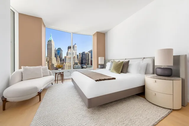 a bedroom with a bed a couch and dresser