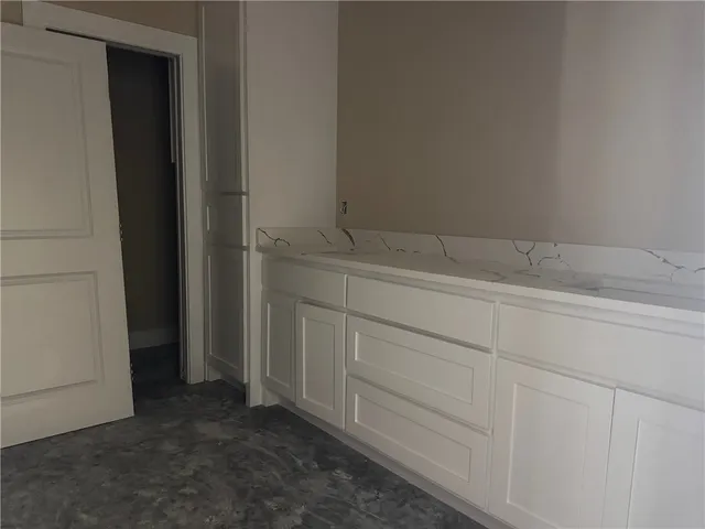 a view of empty room with a fireplace