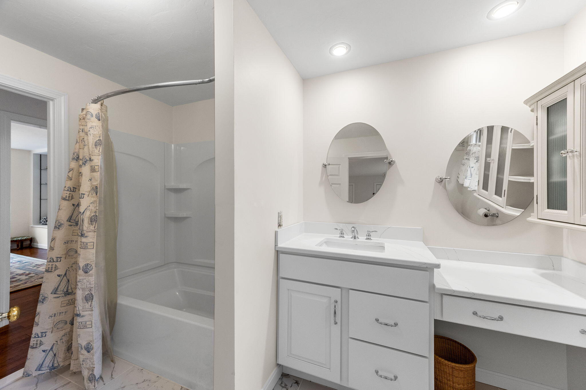 407 Orleans Road, Unit D North Chatham, MA 02650 - Photo 17 of 36 a bathroom with a double vanity sink mirror and bathtub