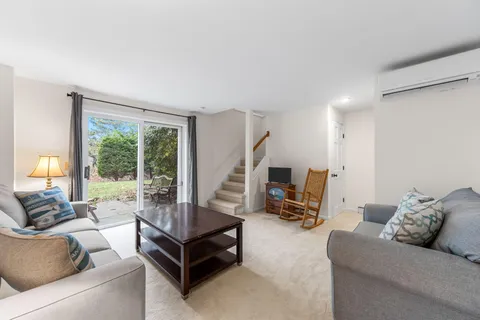 a living room with furniture and a floor to ceiling window