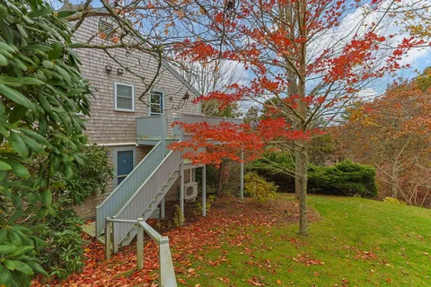 a backyard of a house with table and chairs