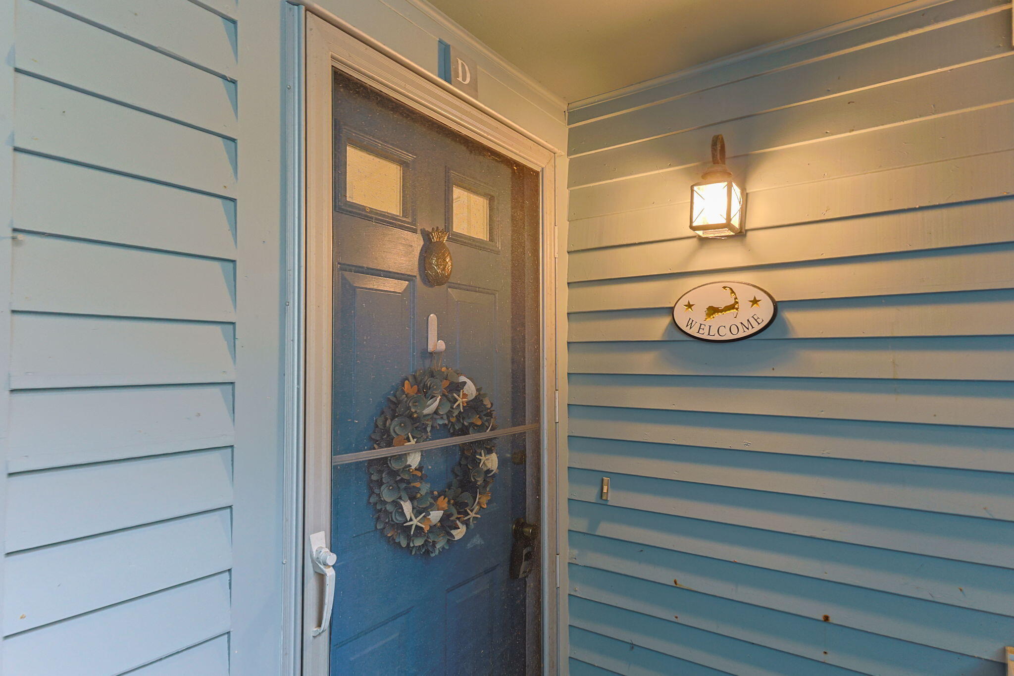 407 Orleans Road, Unit D North Chatham, MA 02650 - Photo 35 of 36 a front view of a house with a wooden floor