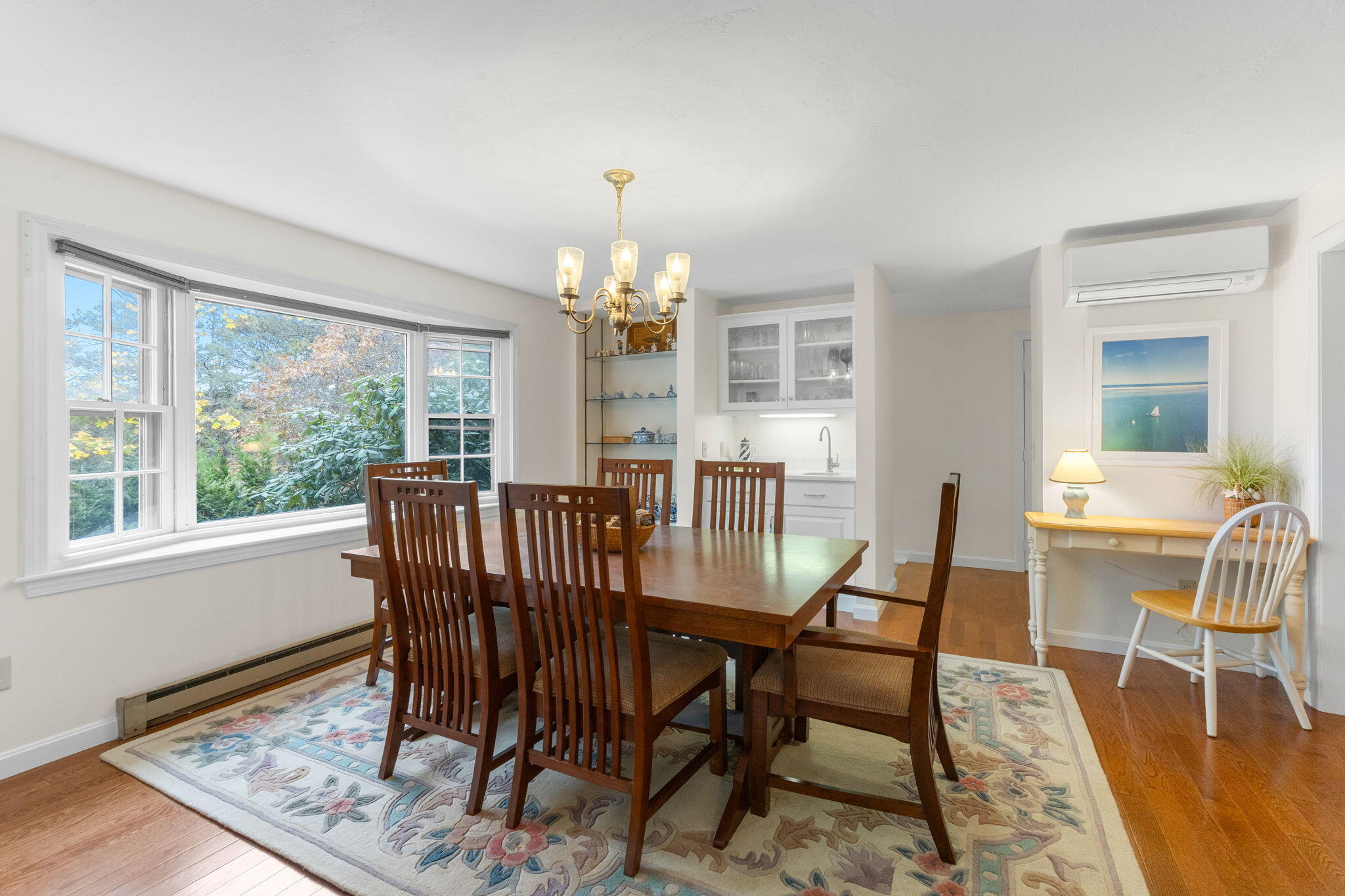 407 Orleans Road, Unit D North Chatham, MA 02650 - Photo 4 of 36 a view of a dining room with furniture a chandelier and wooden floor