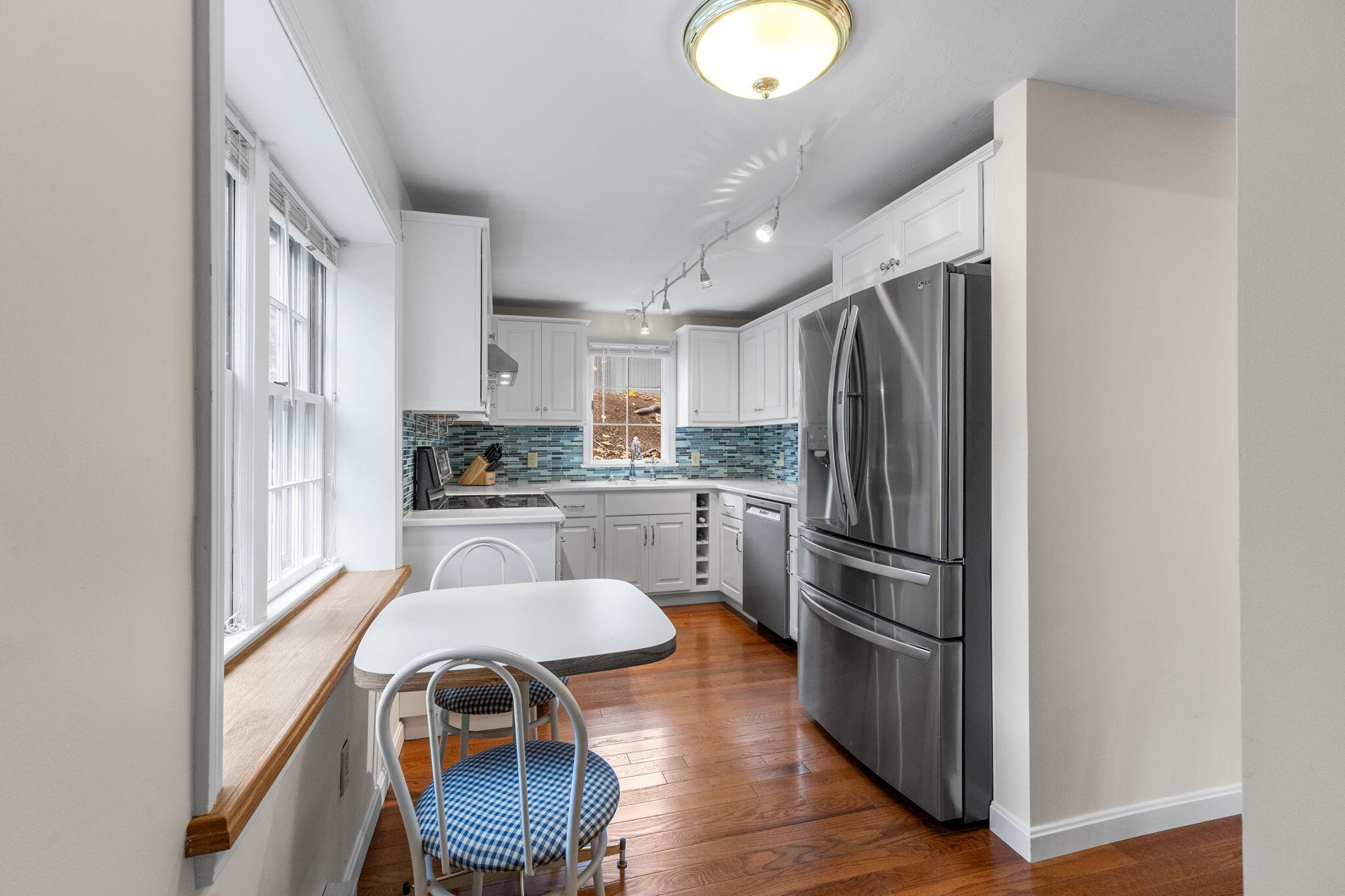 407 Orleans Road, Unit D North Chatham, MA 02650 - Photo 8 of 36 a kitchen with a refrigerator and white appliances