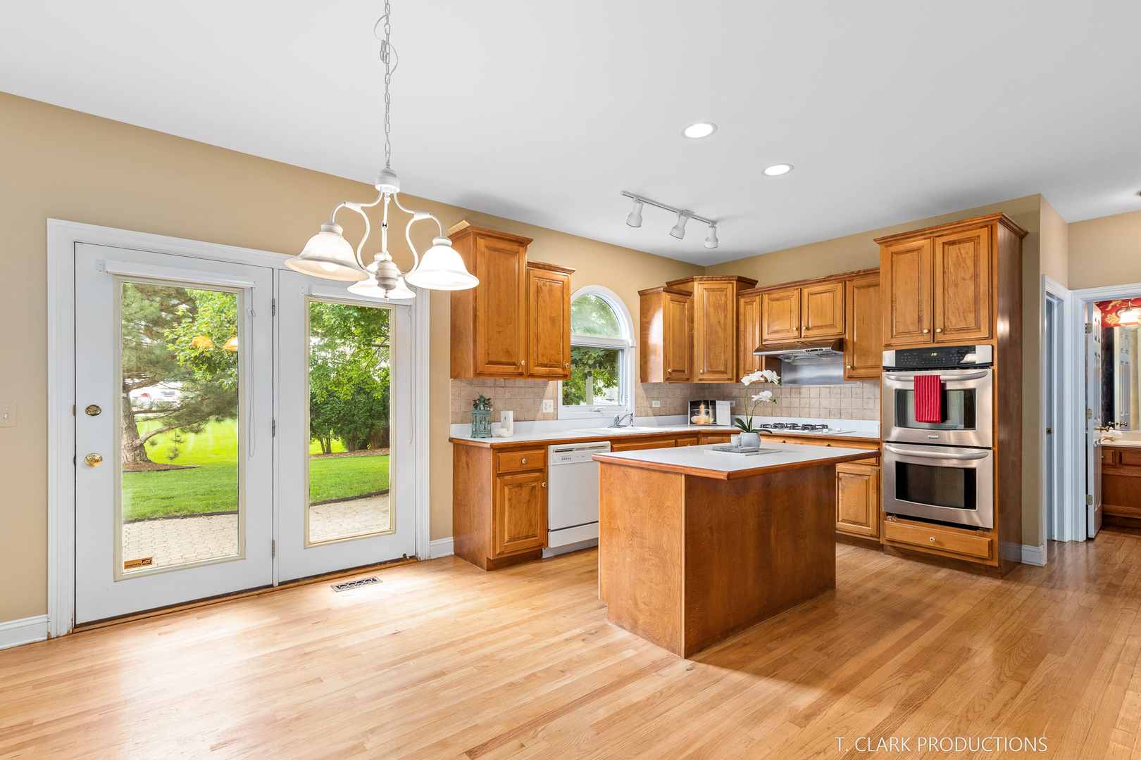 2724 Wait Road Naperville, IL 60564 - Photo 12 of 24 a kitchen with kitchen island granite countertop a stove top oven a sink dishwasher and a fireplace with wooden floor