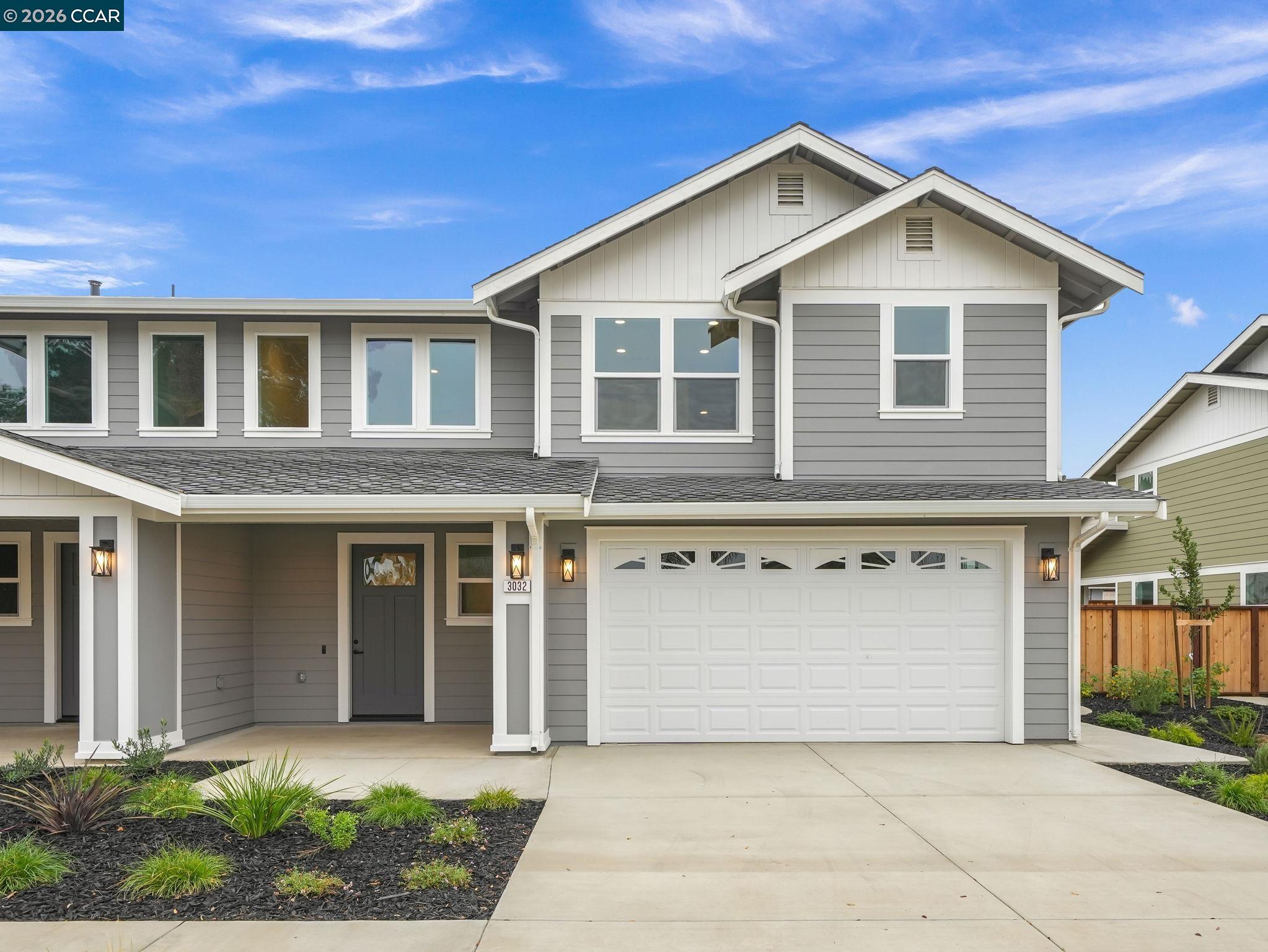 a front view of a house with a yard and garage