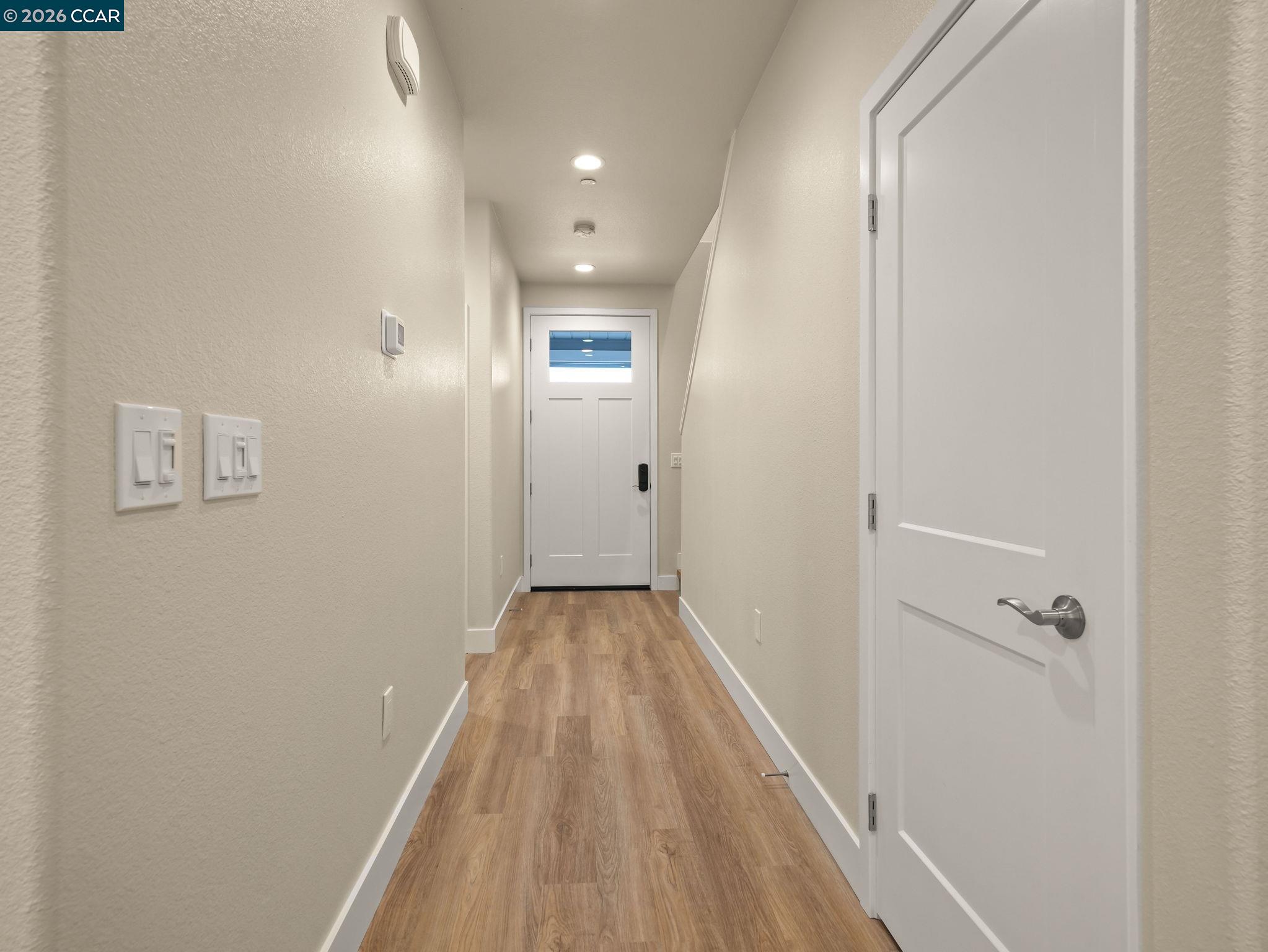 3030 Byron Road Tracy, CA 95377 - Photo 17 of 58 a view of a hallway with wooden floor