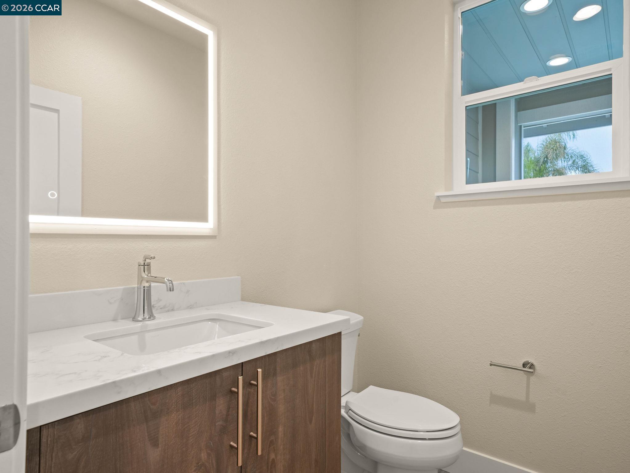 3030 Byron Road Tracy, CA 95377 - Photo 18 of 58 a bathroom with a sink a toilet and a mirror