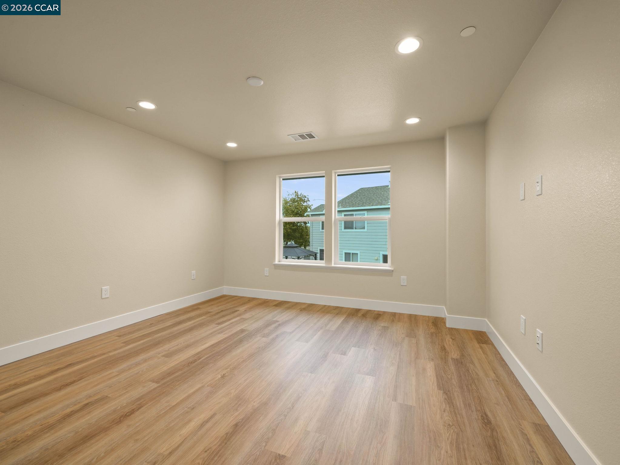 3030 Byron Road Tracy, CA 95377 - Photo 24 of 58 a view of an empty room with wooden floor and a window