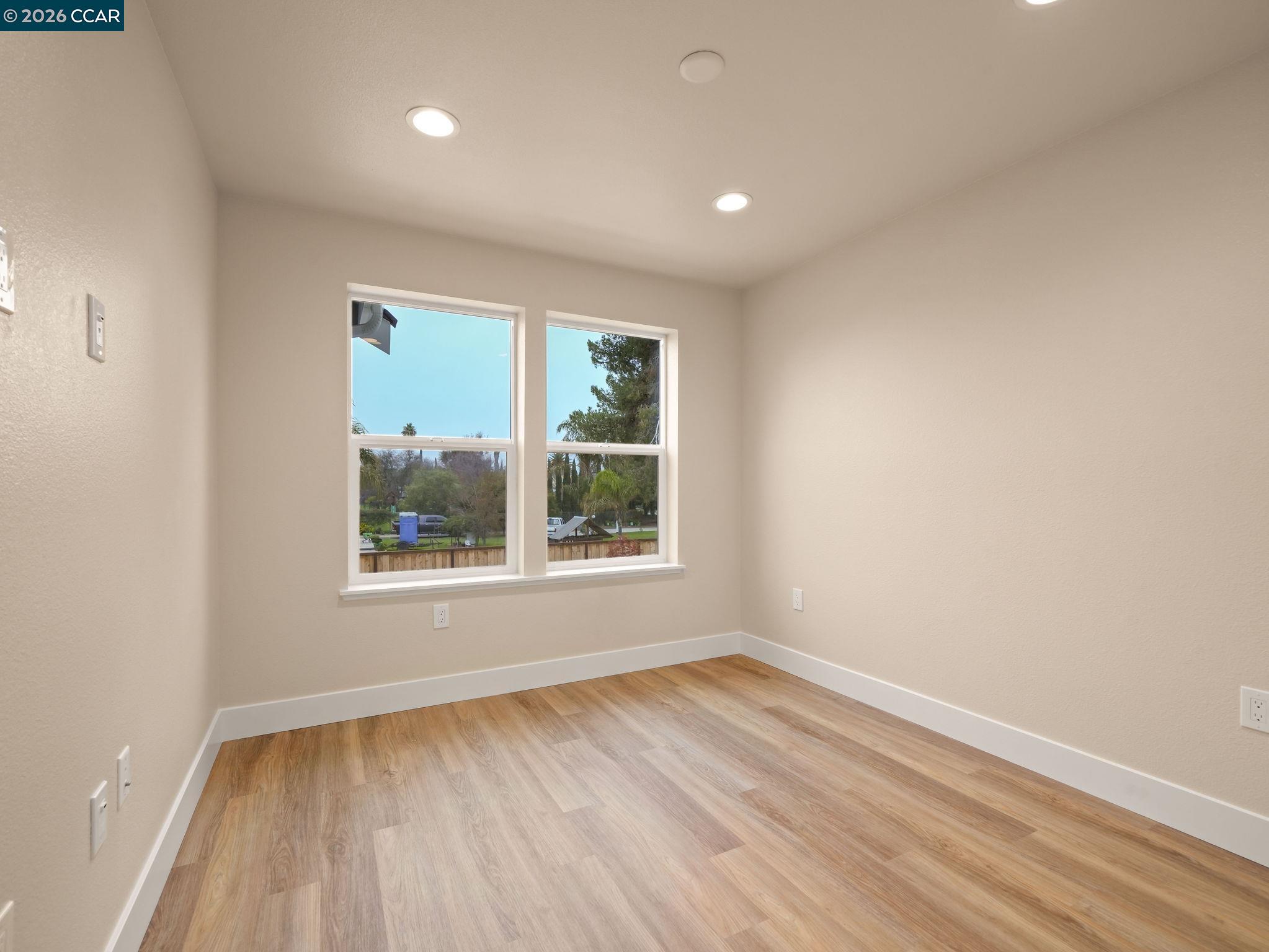 3030 Byron Road Tracy, CA 95377 - Photo 34 of 58 an empty room with wooden floor and windows
