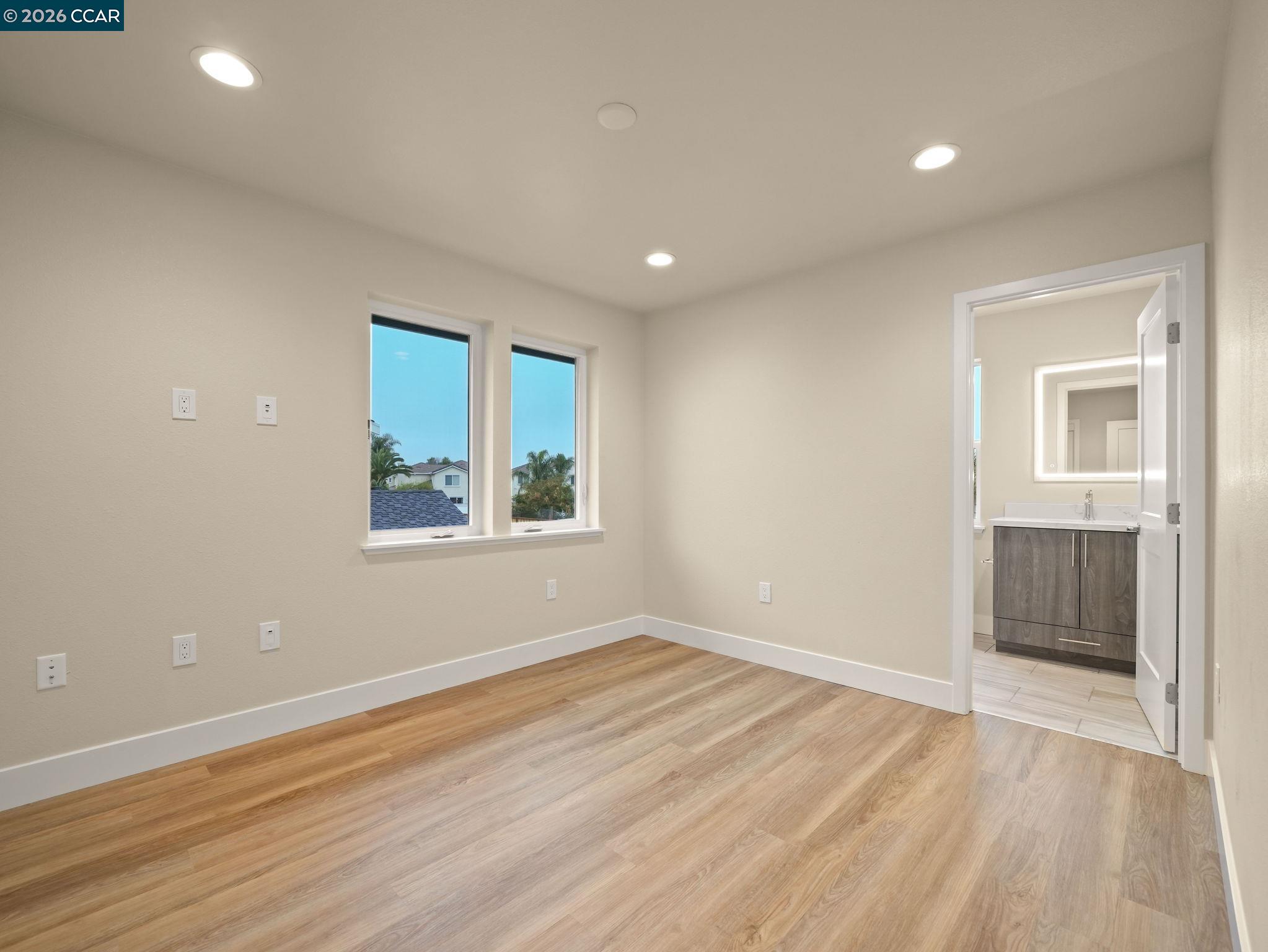 3030 Byron Road Tracy, CA 95377 - Photo 37 of 58 an empty room with wooden floor and windows