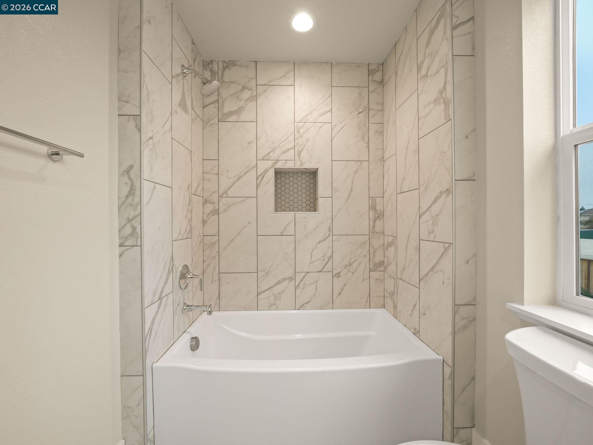3030 Byron Road Tracy, CA 95377 - Photo 40 of 58 a bathroom with a white bath tub and a shower curtain