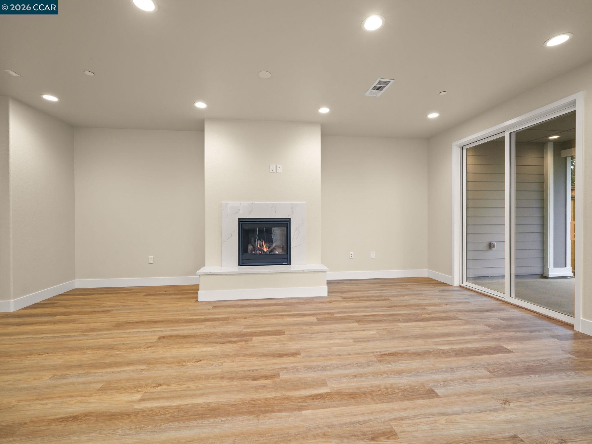 3030 Byron Road Tracy, CA 95377 - Photo 4 of 58 a view of an empty room with wooden floor and a fireplace