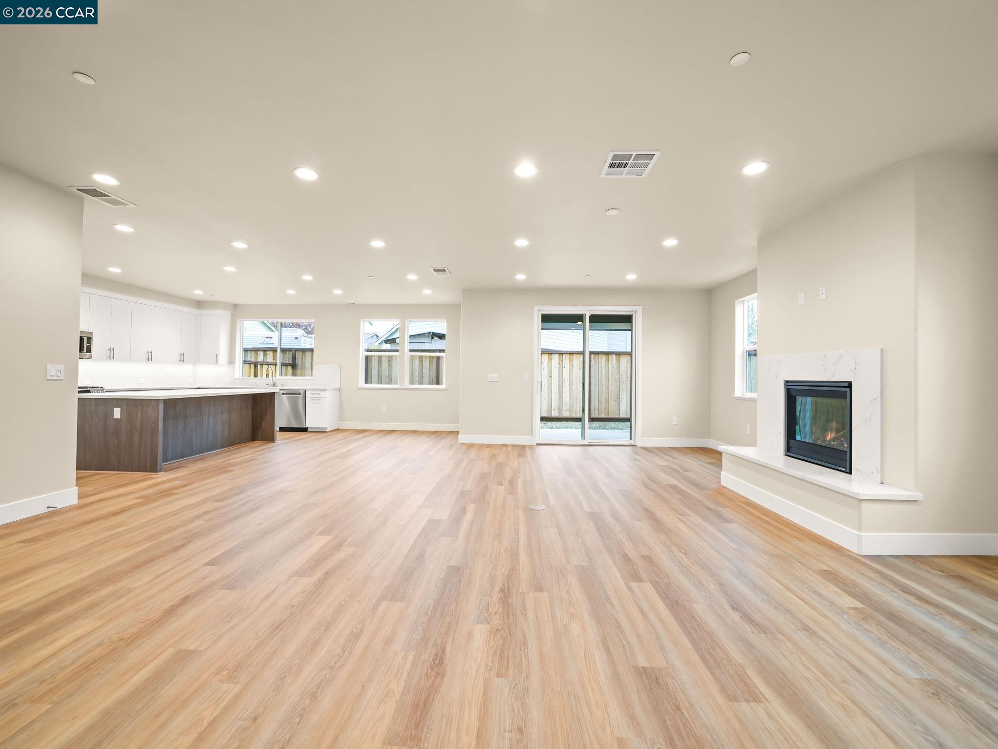 3030 Byron Road Tracy, CA 95377 - Photo 47 of 58 a view of an empty room with wooden floor and a kitchen