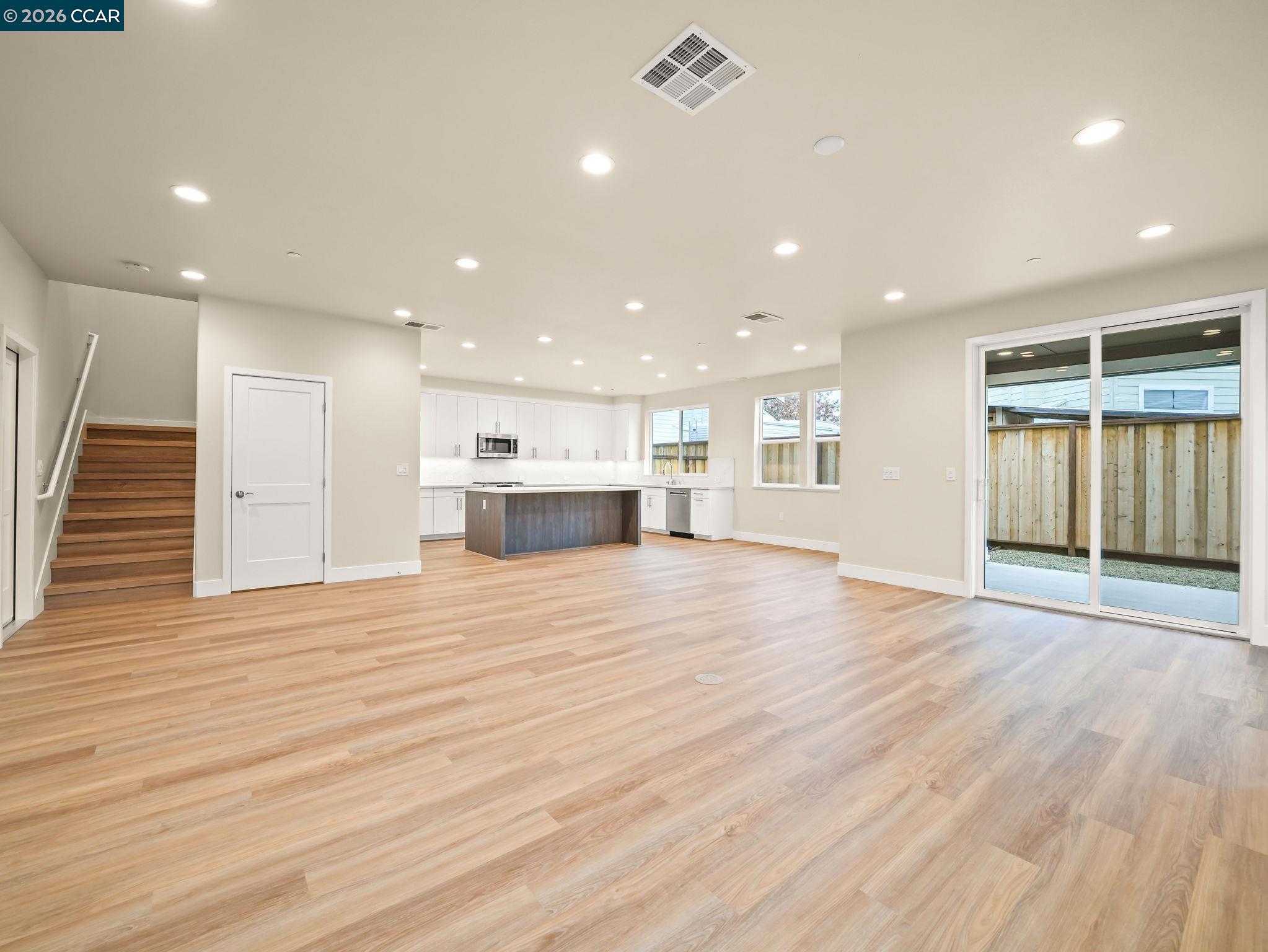 3030 Byron Road Tracy, CA 95377 - Photo 50 of 58 a view of an empty room with wooden floor and kitchen