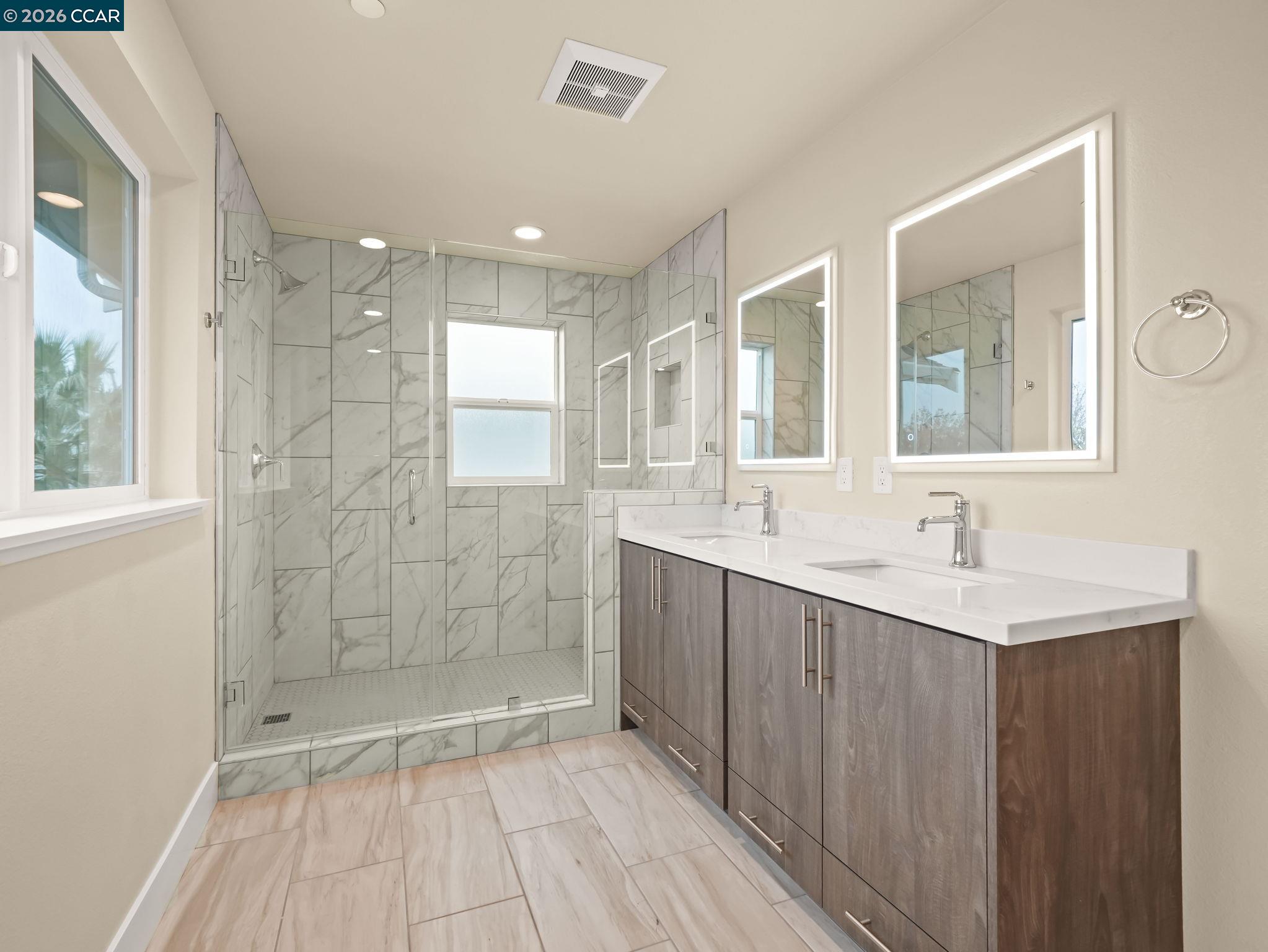 3030 Byron Road Tracy, CA 95377 - Photo 55 of 58 a bathroom with a shower sink and mirror